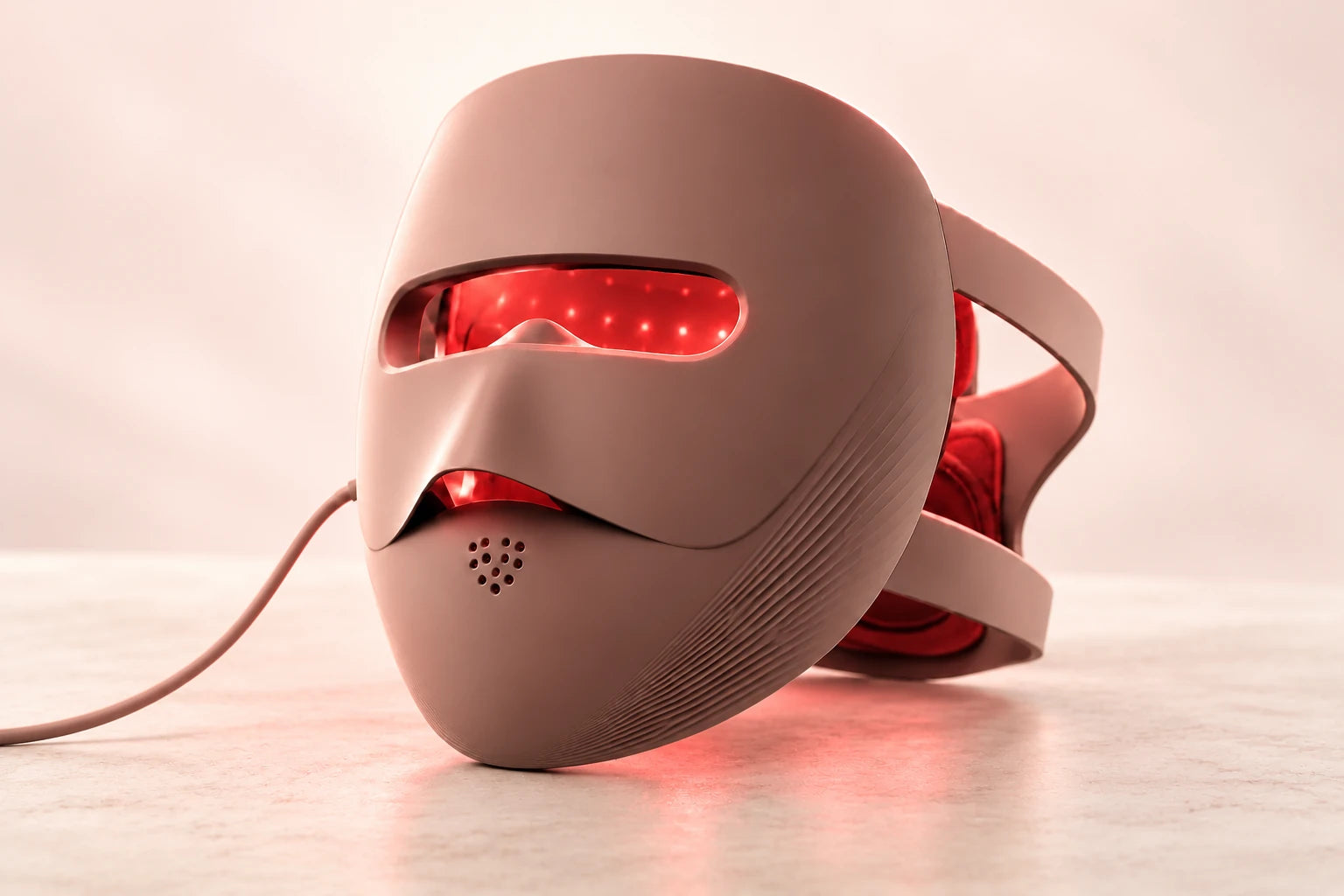Rose-brown mask with red light glowing from its inner surface