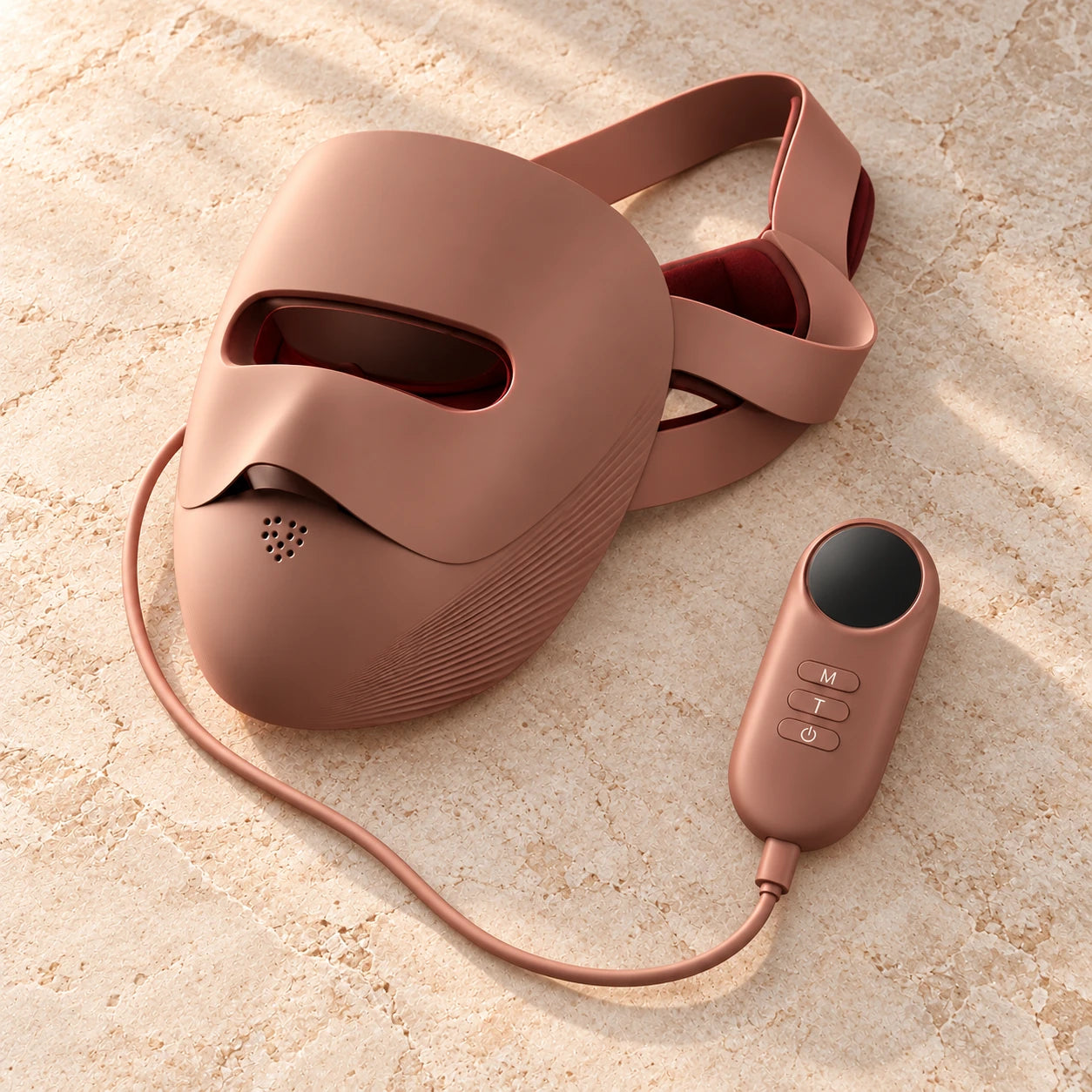 Close-up of the rose-brown mask’s contoured silicone surface and adjustable band